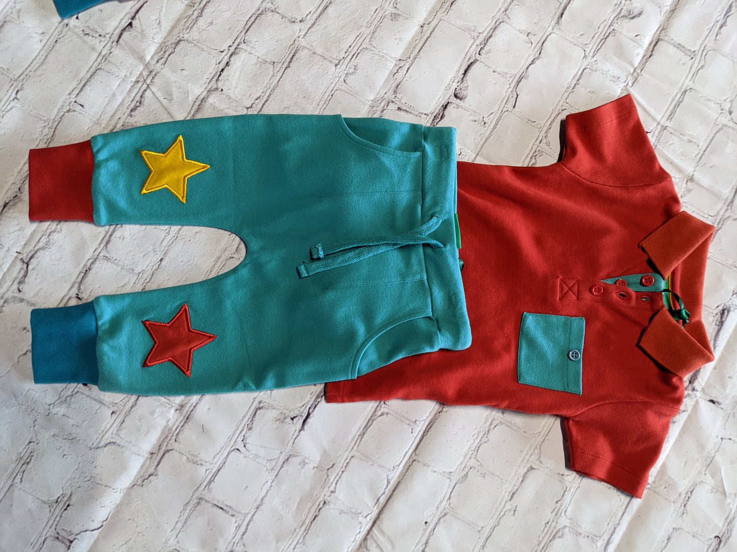 Red polo and teal star pants