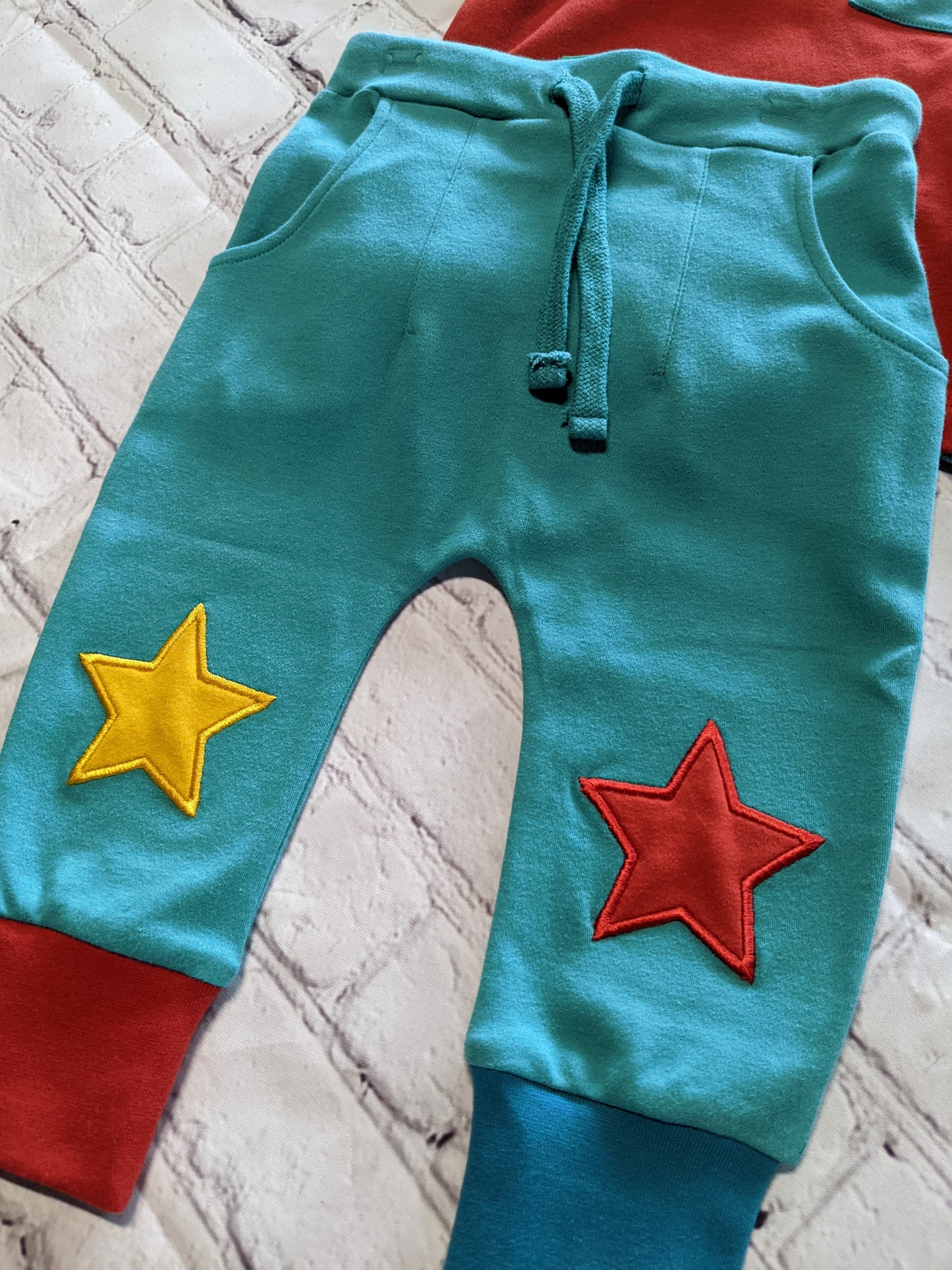 Red polo and teal star pants