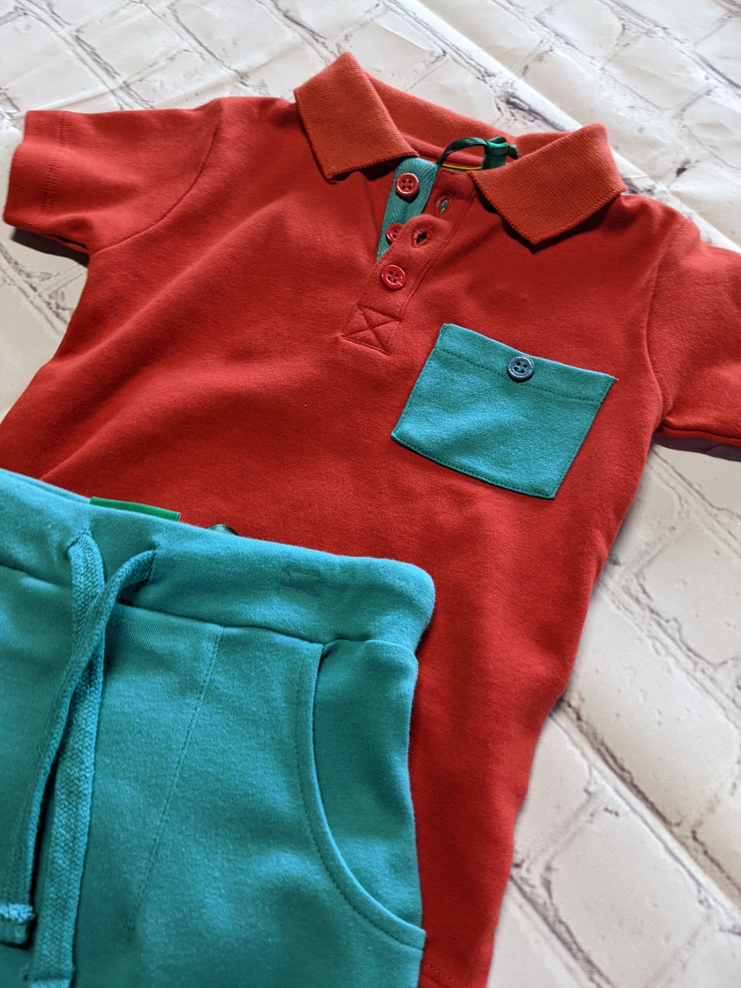 Red polo and teal star pants